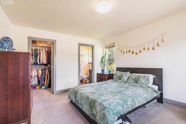 2904 SE 87th Ave, Portland, OR 97266 - carpeted bedroom with a spacious closet, a closet, baseboards, and connected bathroom