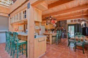 kitchen with tile patterned floors and beamed ceiling