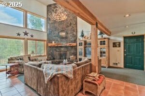 tiled living room featuring a fireplace and high vaulted ceiling