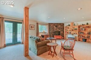 carpeted living area with french doors