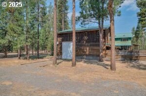 view of outbuilding with an outbuilding and fence