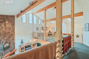 living room with carpet, beam ceiling, and a fireplace