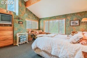 bedroom with carpet flooring, multiple windows, wallpapered walls, and vaulted ceiling with beams