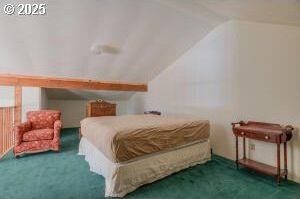 carpeted bedroom featuring lofted ceiling