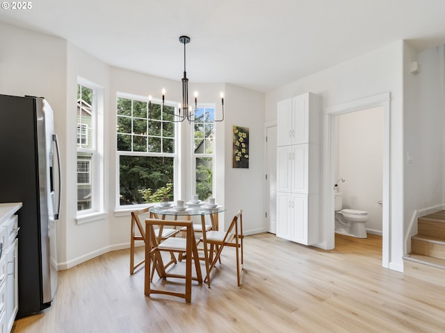 7804 SW Brookline Ln, Portland, OR 97224 - dining space with a chandelier, light wood-style flooring, and stairway