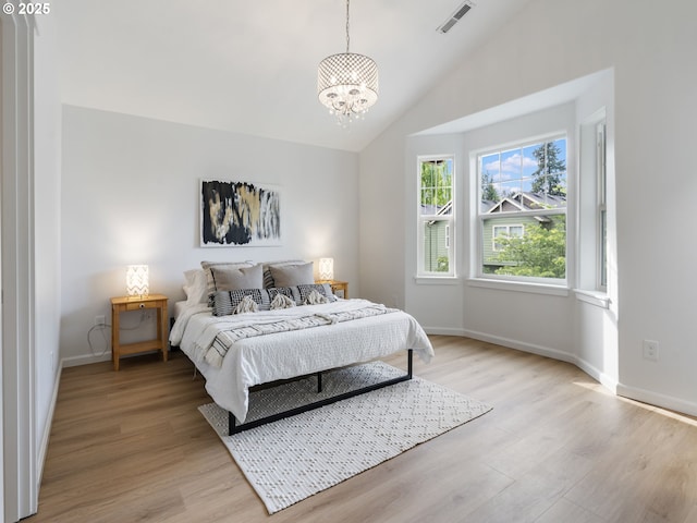 7804 SW Brookline Ln, Portland, OR 97224 - bedroom with a chandelier, light wood-style floors, and high vaulted ceiling