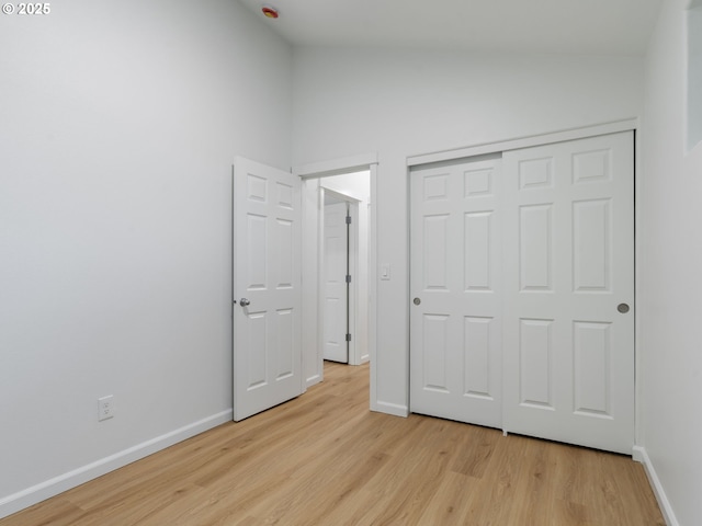 7804 SW Brookline Ln, Portland, OR 97224 - unfurnished bedroom with light wood-style flooring, vaulted ceiling, and a closet
