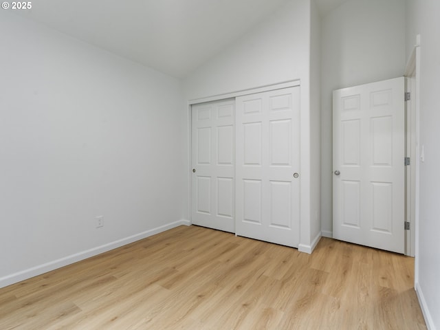 7804 SW Brookline Ln, Portland, OR 97224 - unfurnished bedroom featuring vaulted ceiling, light wood finished floors, and a closet