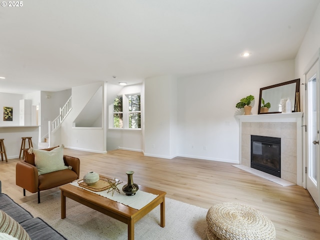 7804 SW Brookline Ln, Portland, OR 97224 - living area with light wood-style flooring, a tiled fireplace, recessed lighting, and stairs