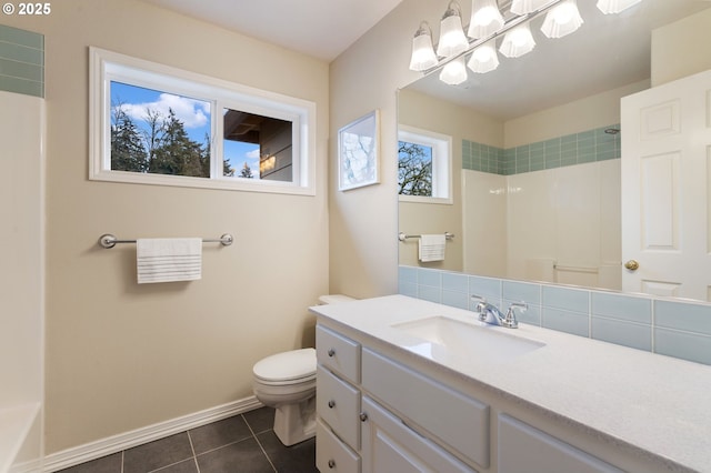 bathroom featuring toilet, vanity, tile patterned flooring, and tasteful backsplash