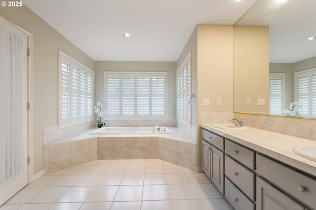 bathroom with vanity, tile patterned flooring, and a relaxing tiled tub