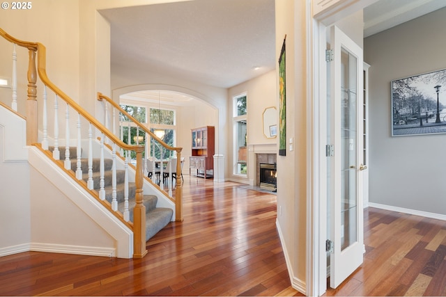 foyer with hardwood / wood-style flooring and a tiled fireplace