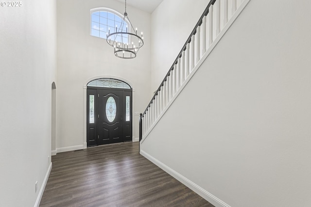 6609 Palomino Cir, West Linn, OR 97068 - foyer entrance with a chandelier, dark wood-type flooring, stairway, arched walkways, and a towering ceiling