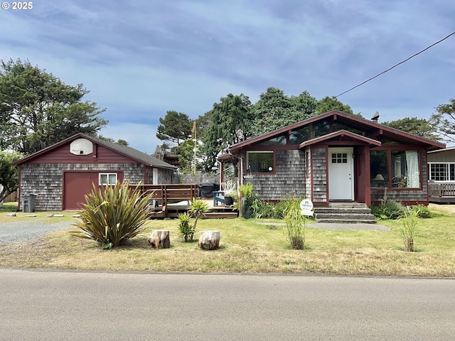 25760 Nedonna Ave, Rockaway Beach, OR 97136 - view of front facade with gravel driveway, an outdoor structure, and a front lawn