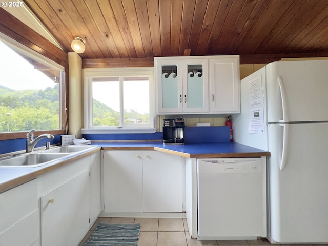 25760 Nedonna Ave, Rockaway Beach, OR 97136 - kitchen featuring white appliances, white cabinets, wooden ceiling, light tile patterned flooring, and glass insert cabinets