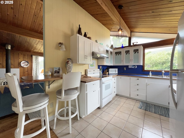 25760 Nedonna Ave, Rockaway Beach, OR 97136 - kitchen featuring white appliances, under cabinet range hood, a wooden ceiling with exposed beams, light tile patterned floors, and glass insert cabinets