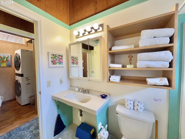 25760 Nedonna Ave, Rockaway Beach, OR 97136 - bathroom with estacked washer and dryer and wood finished floors