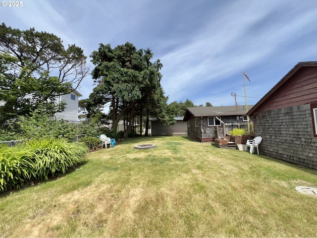 25760 Nedonna Ave, Rockaway Beach, OR 97136 - view of yard with an outdoor fire pit and an outdoor structure