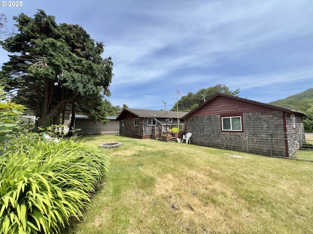 25760 Nedonna Ave, Rockaway Beach, OR 97136 - view of yard with an outdoor fire pit