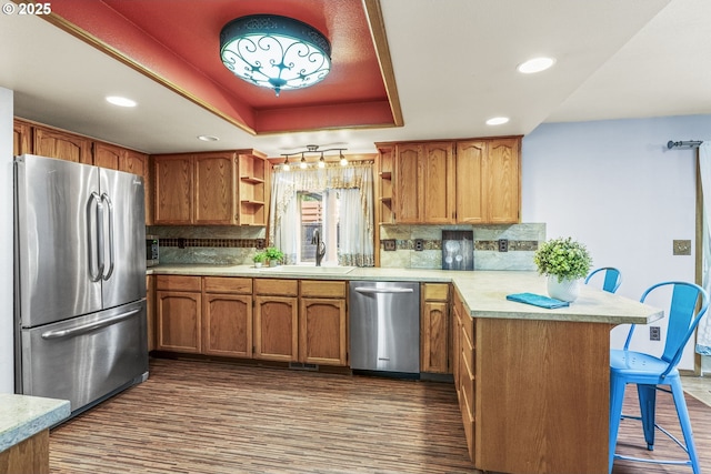 15711 NE 27th Cir, Vancouver, WA 98684 - kitchen with appliances with stainless steel finishes, open shelves, a peninsula, a tray ceiling, and a sink
