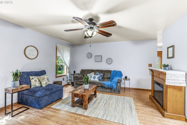 15711 NE 27th Cir, Vancouver, WA 98684 - living area with light wood-style flooring, ceiling fan, baseboards, and a glass covered fireplace