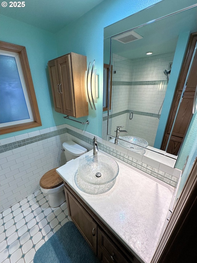 15711 NE 27th Cir, Vancouver, WA 98684 - bathroom with toilet, a stall shower, vanity, tile walls, and wainscoting