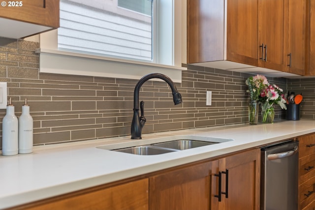 29250 SW Costa Cir E, Wilsonville, OR 97070 - kitchen with a sink, brown cabinetry, decorative backsplash, dishwasher, and light countertops