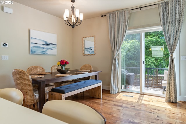 29250 SW Costa Cir E, Wilsonville, OR 97070 - dining room with a chandelier, wood finished floors, and baseboards