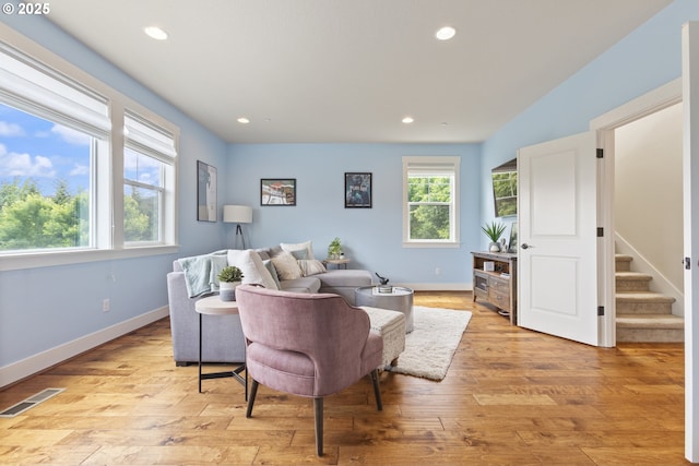 29250 SW Costa Cir E, Wilsonville, OR 97070 - living room with plenty of natural light, recessed lighting, light wood-style floors, stairway, and baseboards