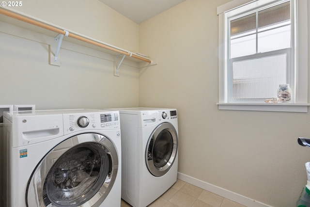 29250 SW Costa Cir E, Wilsonville, OR 97070 - laundry area with washing machine and clothes dryer, baseboards, and light tile patterned floors