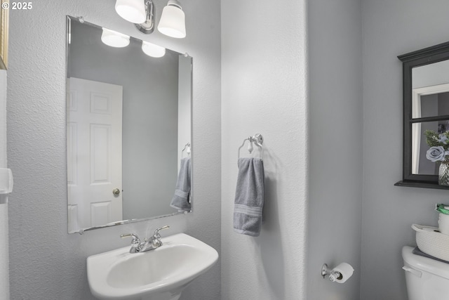 bathroom featuring a sink and toilet