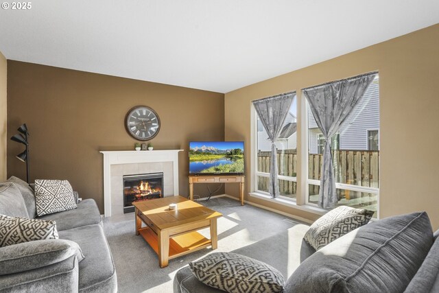 living room featuring carpet and a fireplace
