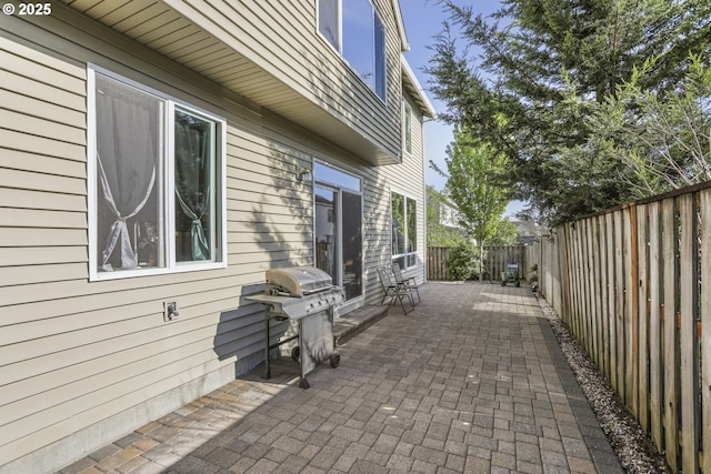 view of side of home with a patio and a fenced backyard