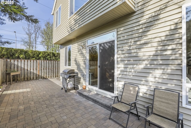 view of patio featuring area for grilling and fence