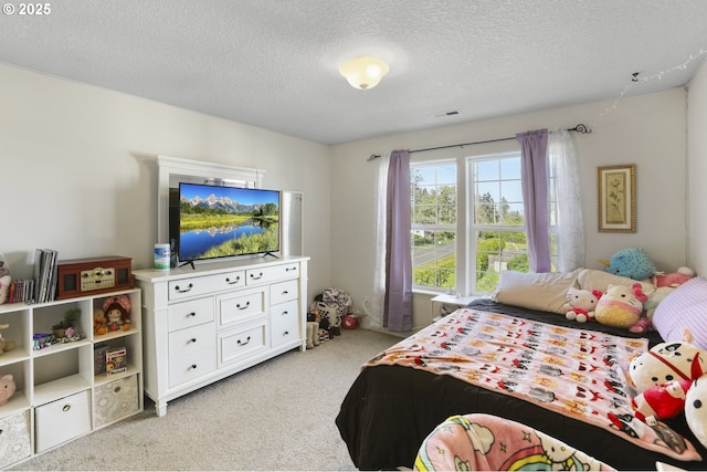 bedroom featuring visible vents, carpet flooring, and a textured ceiling