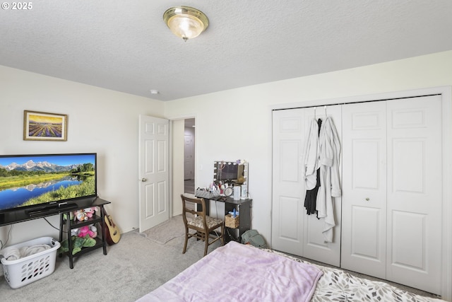 bedroom featuring a closet, a textured ceiling, and carpet floors