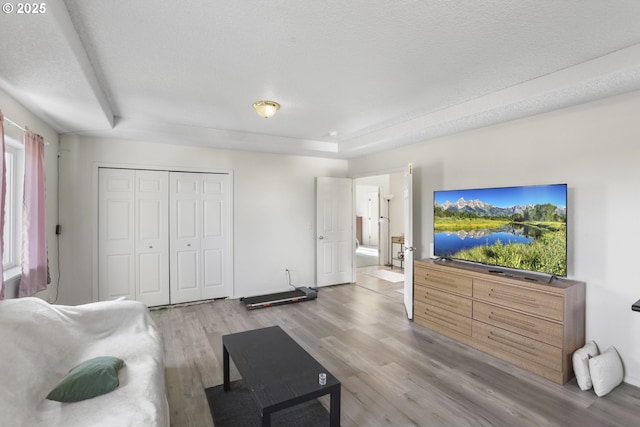 living area featuring a textured ceiling and light wood finished floors