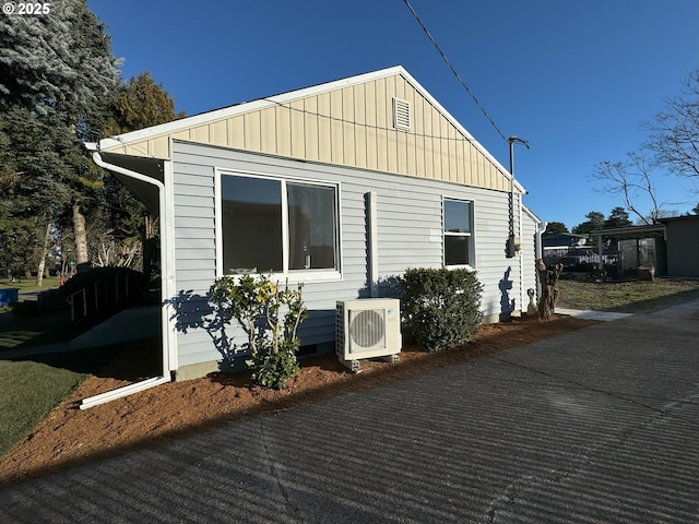 view of home's exterior with ac unit, crawl space, and board and batten siding