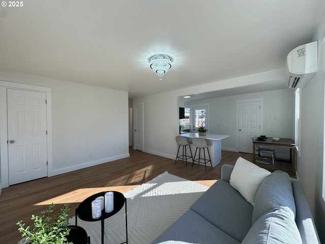 living room featuring dark wood-style floors, baseboards, and a wall mounted air conditioner