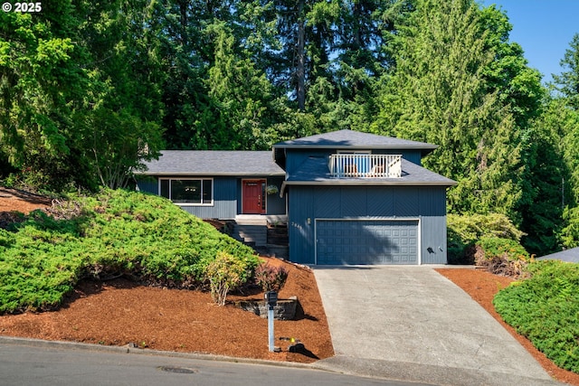2845 SW Raleighview Dr, Portland, OR 97225 - tri-level home featuring a balcony, concrete driveway, and a garage