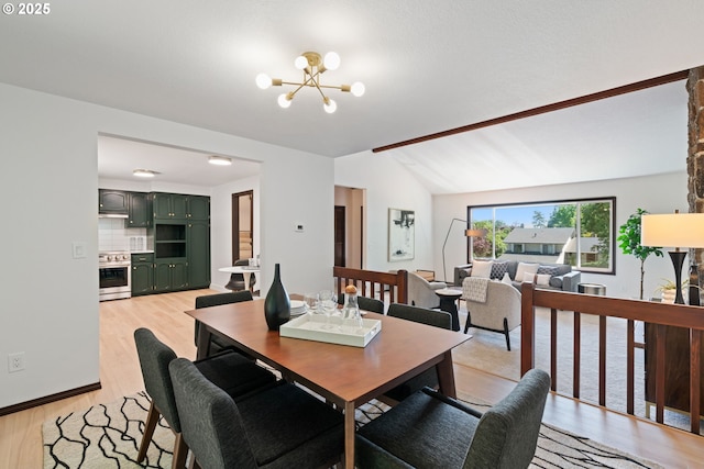 2845 SW Raleighview Dr, Portland, OR 97225 - dining space featuring a chandelier, light wood-style floors, and lofted ceiling