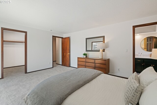 2845 SW Raleighview Dr, Portland, OR 97225 - bedroom with light colored carpet, connected bathroom, a walk in closet, and a closet
