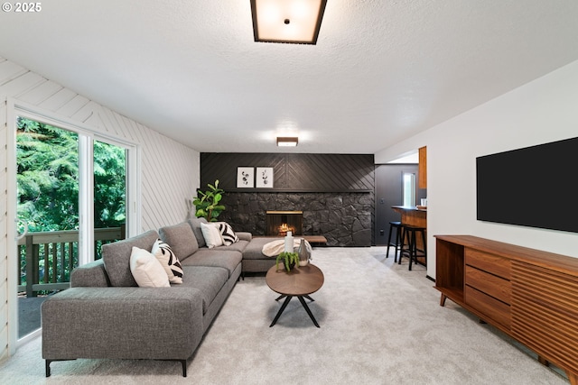 2845 SW Raleighview Dr, Portland, OR 97225 - living area with a stone fireplace, light colored carpet, and an accent wall