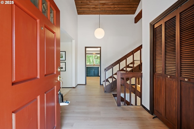 2845 SW Raleighview Dr, Portland, OR 97225 - foyer entrance featuring a high ceiling, wood ceiling, light wood finished floors, stairs, and baseboards