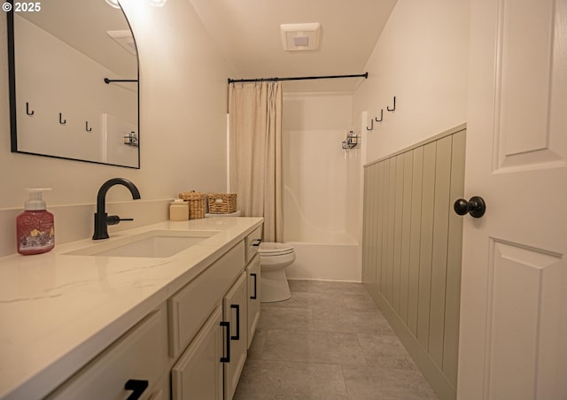 bathroom featuring toilet, shower / bath combo, and vanity