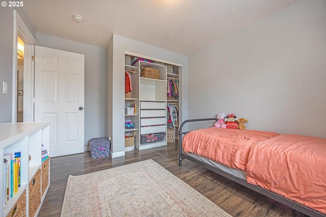 bedroom featuring dark wood-style flooring and a closet
