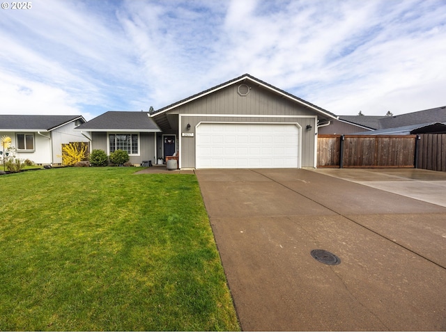 ranch-style home featuring a front yard, fence, a garage, and concrete driveway