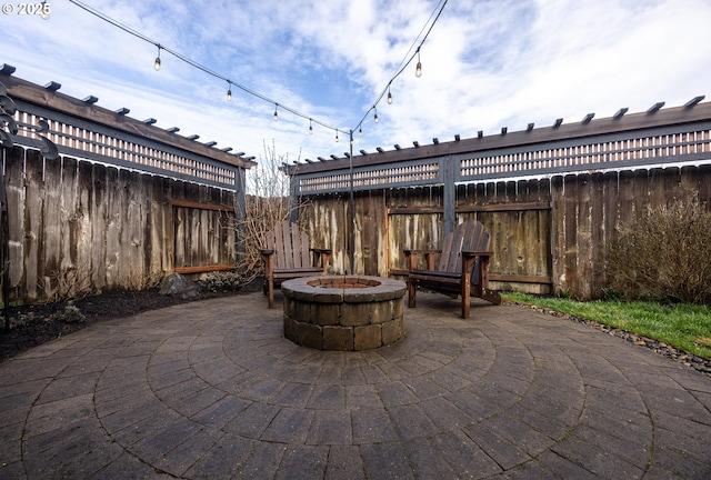 view of patio / terrace featuring a fire pit and fence