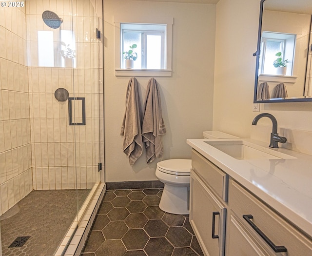 bathroom with a shower stall, tile patterned floors, vanity, and toilet