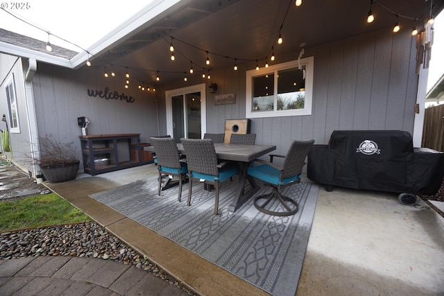deck with outdoor dining space and a patio